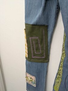 image of upcycled, thrifted jeans, worked with deadstock and reclaimed fabrics and embellishments