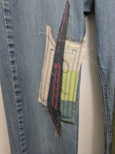 image of upcycled, thrifted jeans, worked with deadstock and reclaimed fabrics and embellishments